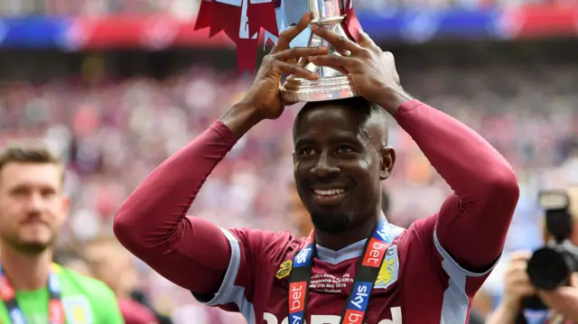 Albert Adomah of Aston Villa celebrates with the trophy after the play-off final win