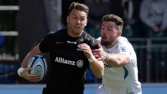 Alex Cuthbert of Exeter attempts to tackle Alex Lewington of Saracens