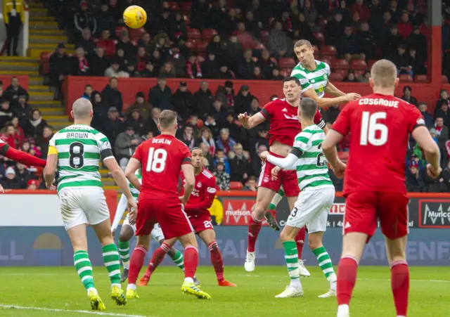 Jozo Simunovic rises high above Scott McKenna to crash in an impressive header