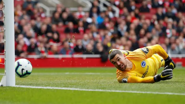 Henrikh Mkhitaryan's shot hits the post watched by Mat Ryan