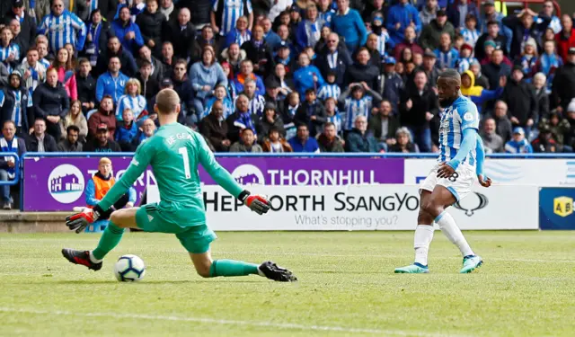 Isaac Mbenza puts the ball through the legs of Man Utd keeper David de Gea