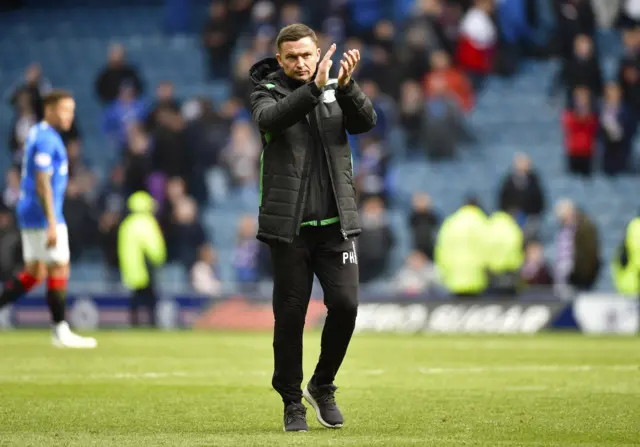 Paul Heckingbottom applauds the small band of away fans at Ibrox