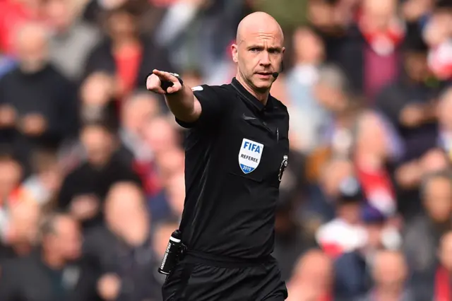 Referee Anthony Taylor points to the spot
