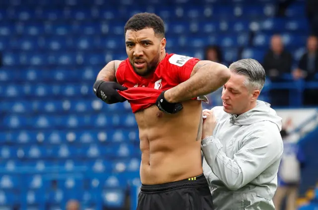 Troy Deeney receives treatment in the warm-up