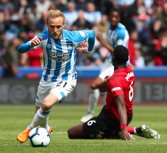 Paul Pogba on his knees, appealing, after Alex Pritchard moves away with the ball