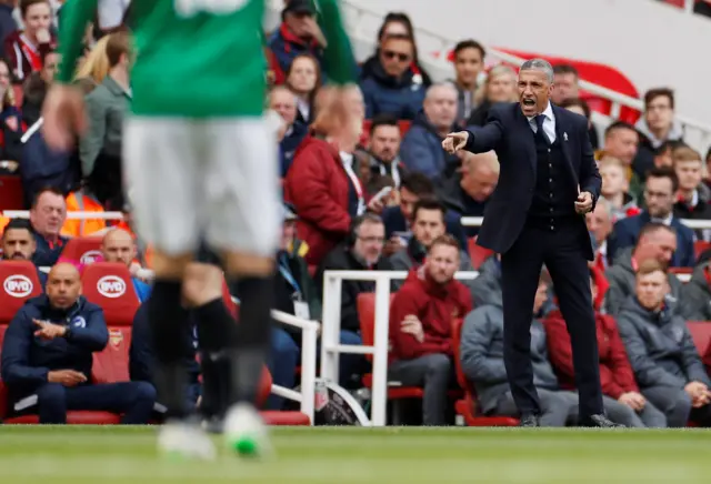 Chris Hughton gestures from the touchline