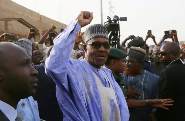 Muhammadu Buhari gestures as he arrives to cast a vote in Nigeria's presidential election at a polling station in Daura, Katsina State, Nigeria, February 23, 2019