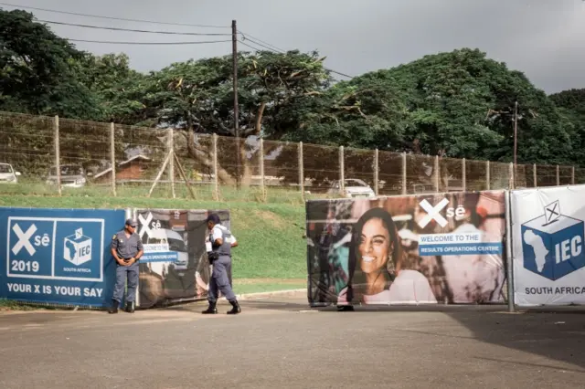 This picture taken on May 6, 2019 shows members of the South African Police Services (SAPS) deployed at the Kwazulu-Natal headquarters of the Independent Election Commission (IEC) and the results operation centre