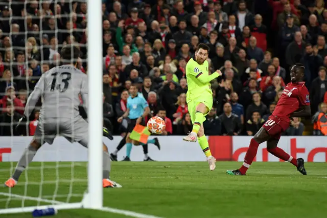 Alisson Becker saves a shot from Lionel Messi