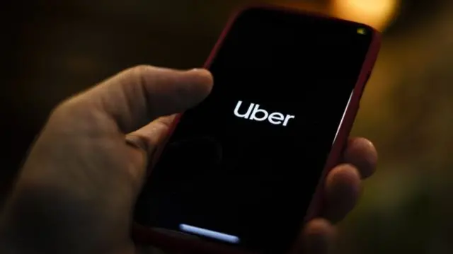 A smartphone showing the Uber logo