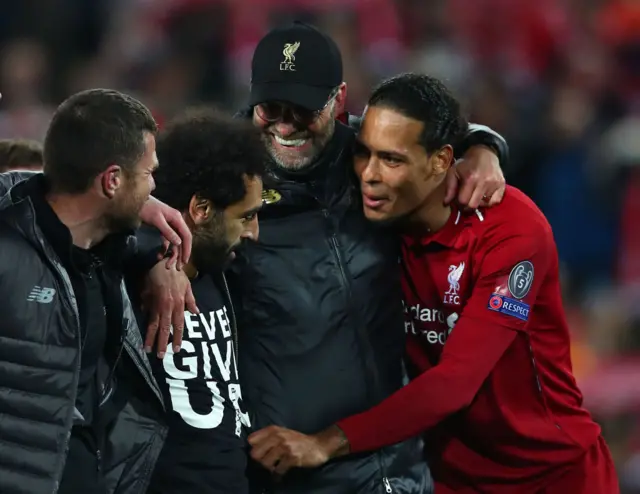 Jurgen Klopp hugs Mohamed Salah and Virgil Van Dijk