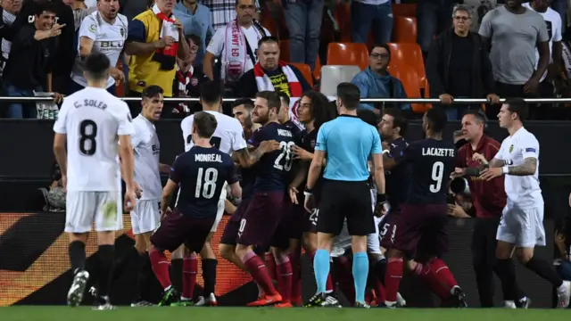 Arsenal and Valencia players square up at full time