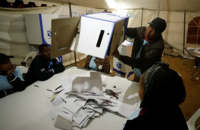 An election official empties a ballot box as counting begins after polls closed in Alexandra township in Johannesburg, South Africa, May 8,2019