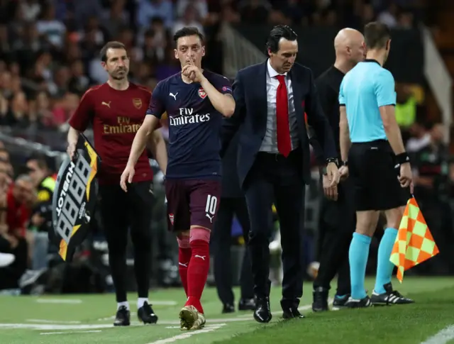 Mesut Ozil gestures to the Valencia fans after he is substituted