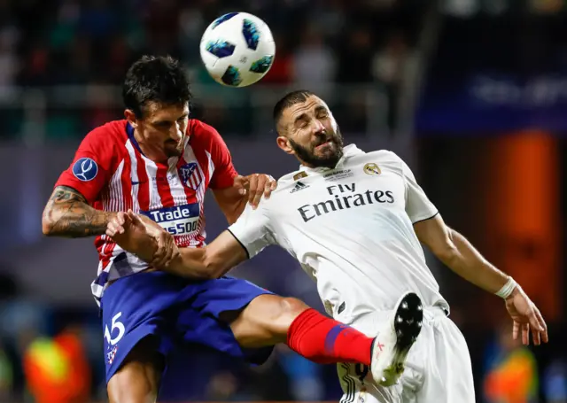 Karim Benzema, of Real Madrid, and Stefan Savic, of Atletico Madrid, vie for a header during the UEFA Super Cup match between Real Madrid and Atletico Madrid