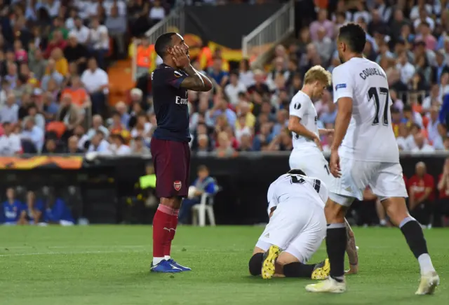 Alexandre Lacazette reacts after shot hits the woodwork