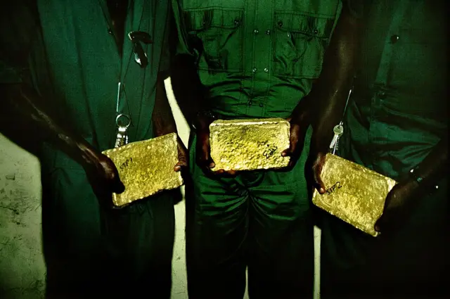 People holding gold bars