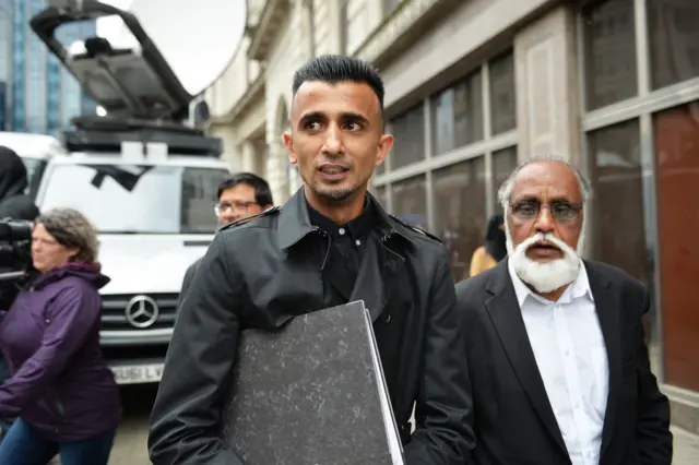 Protester Shakeel Afsar (centre) outside the Priory Law Courts in Birmingham