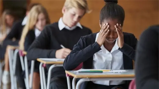 School girl with head in hands