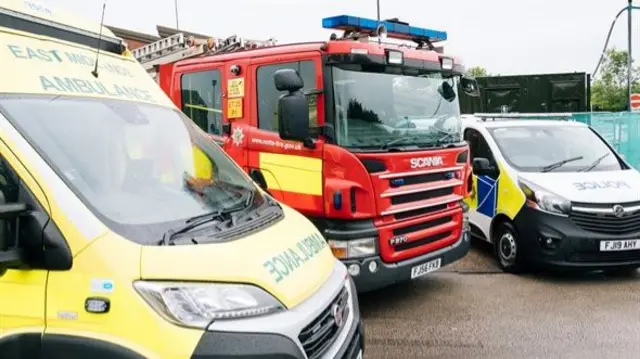 Ambulance, fire engine and police car parked side-by-side