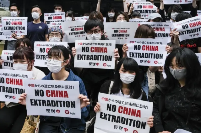 Foreign students In Japan hold up a placard which says No China Extradition at Meiji University on June 12, 2019 in Tokyo, Japan.