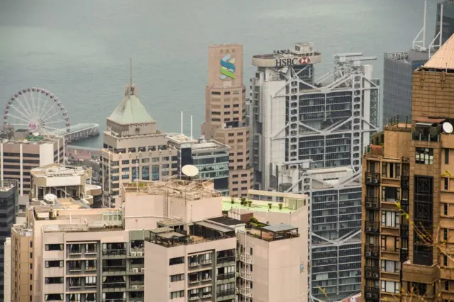 The local HSBC bank headquarters (background centre R) is seen beside the Standard Chartered bank building (background C) amongst other residential and commercial buildings in Hong Kong on September 27, 2018.