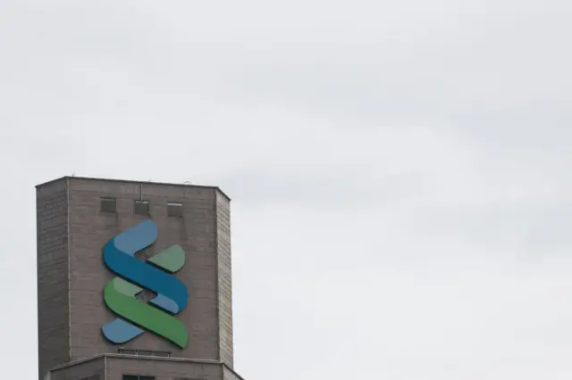 A Standard Chartered Plc logo is displayed atop at the Standard Chartered Bank Building on July 16, 2018 in Hong Kong, Hong Kong.