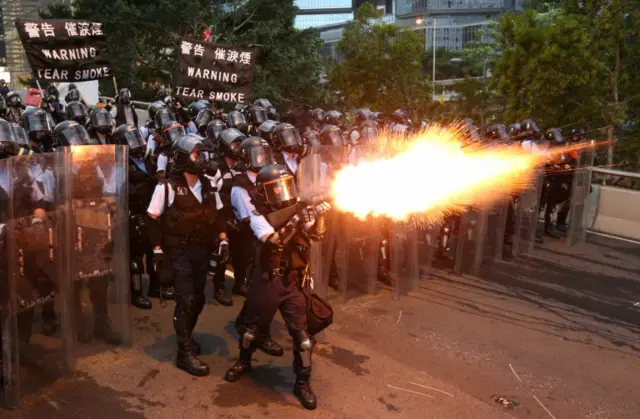 Police officers fire a tear gas during a demonstration against a proposed extradition bill in Hong Kong, China June 12, 2019.