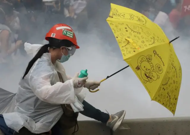 A protester holds an umbrella during a demonstration against a proposed extradition bill in Hong Kong, China June 12, 2019