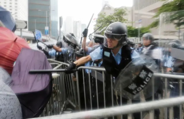 Protesters clash with riot police during a demonstration against a proposed extradition bill,