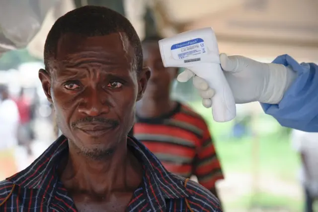 Man having his temperature taken