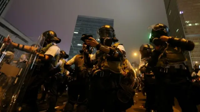 Riot police prepare their gear during a demonstration against a proposed extradition bill in Hong Kong, China June 12, 2019