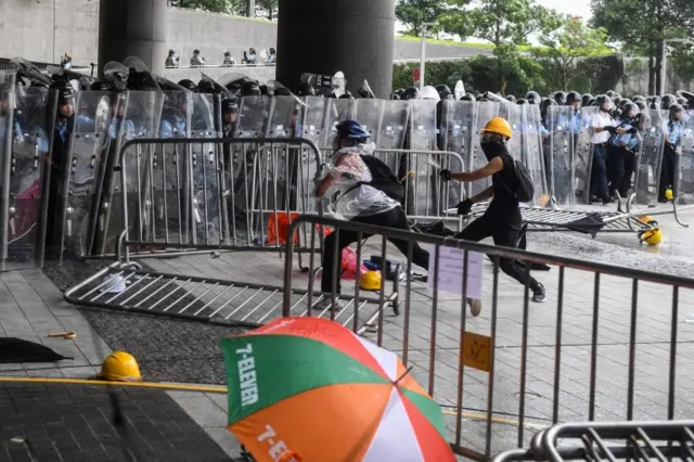 Protesters clash with police during a demonstration outside the Legislative Council Complex in Hong Kong