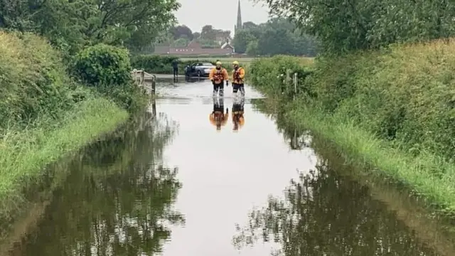 Firefighters in flood water