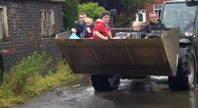 People in a digger bucket