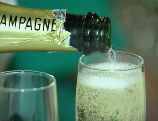 A champagne bottle and glass of champagne