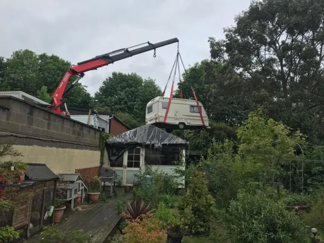 Caravan being lifted in