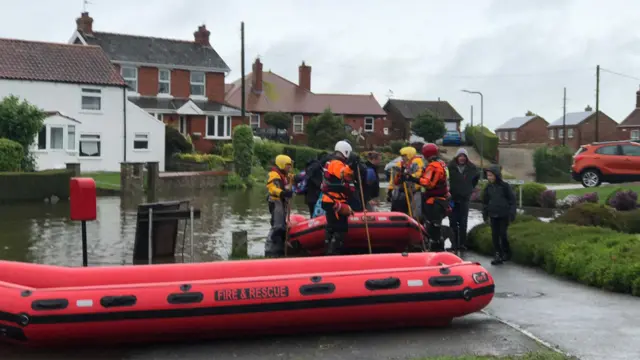 People being evacuated in rescue dinghie