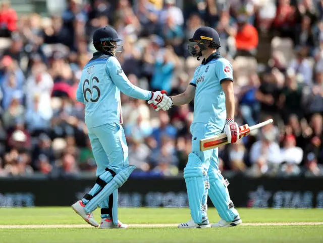 England's Joe Root celebrates a half century with Chris Woakes