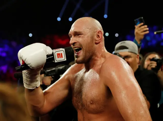 Tyson Fury speaks into the microphone