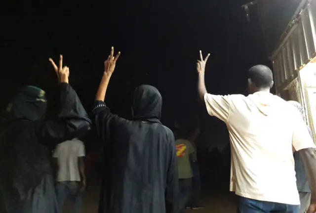 Protesters pictured flashing the V-sighn in Khartoum, in January 2019