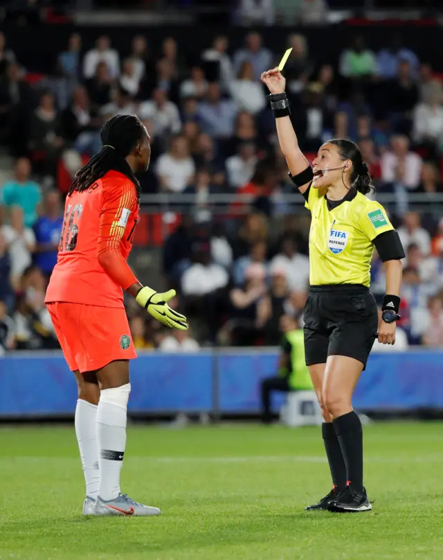 The Nigeria goalkeeper is shown a yellow card