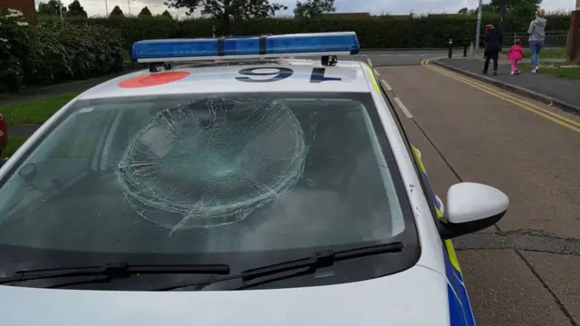 Police car with a smashed windscreen