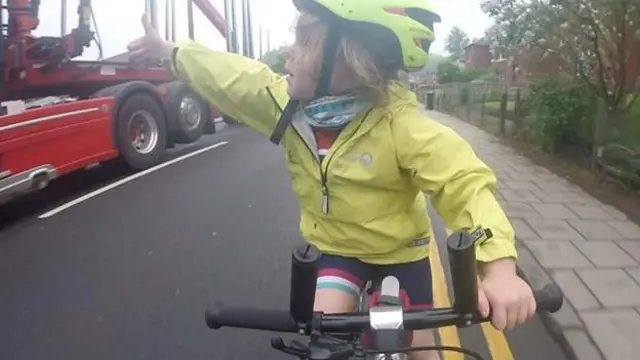 Rhoda Jones was riding on a trailer bike with her father Tom in Scotland and the video went viral as she gives a thumbs up to a truck leaving plenty of roomImage