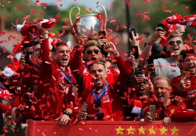 Liverpool players cheer on victory parade