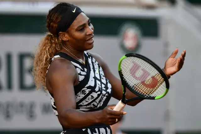 Serena Williams holds her hands up in frustration