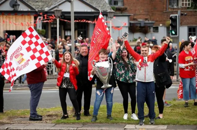 Liverpool fans line the streets