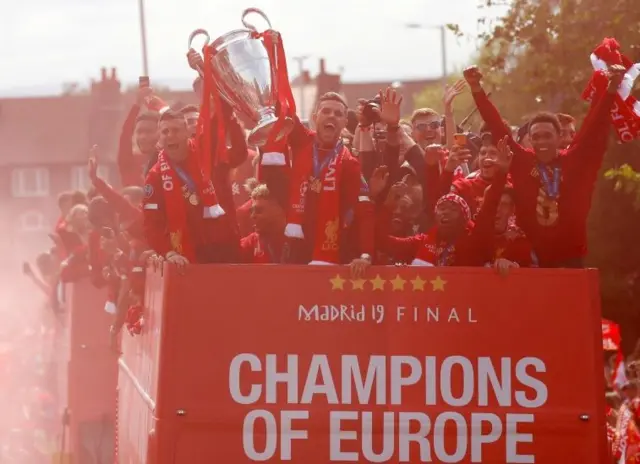 Liverpool"s Jordan Henderson and James Milner with the trophy during the parade