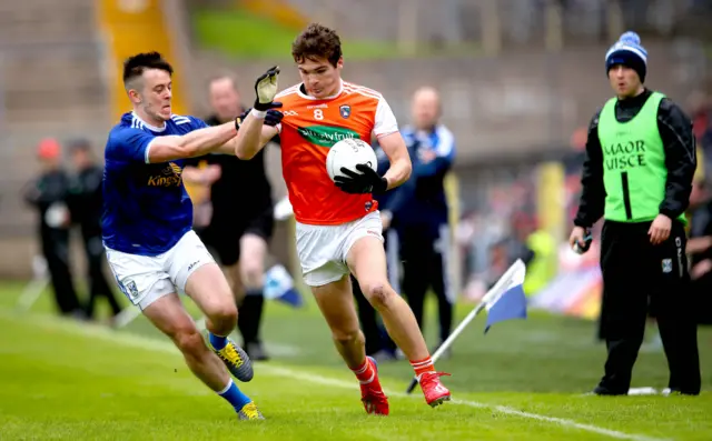 Cavan's Gerard Smith has a little tug on the jersey of Jarlath Og Burns
