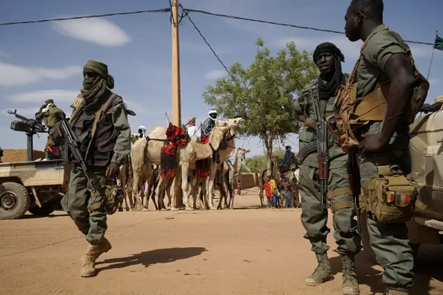 Malian soldiers patrol the roads in Menaka, Mali